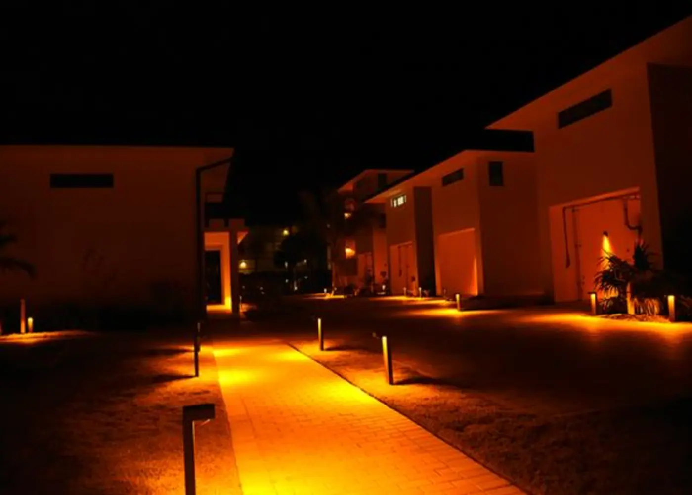 Bollards lighting a resort walkway at night