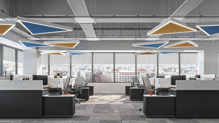 Plyta Triangle pendants, lit and unlit, in two colors over an open office.