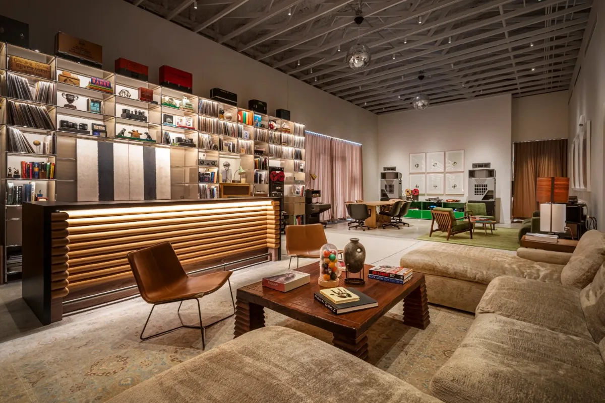 Soundlux Studio listening room in Miami with internally lit record shelving and a continuous warm light line along the bar front