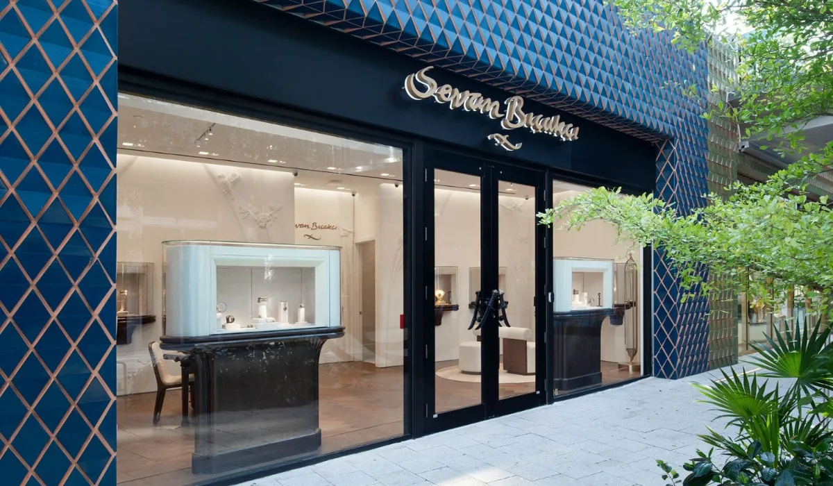 The Sevan Bicakci storefront in the Miami Design District, with a blue diamond-tiled facade and lit display cases visible through the glass