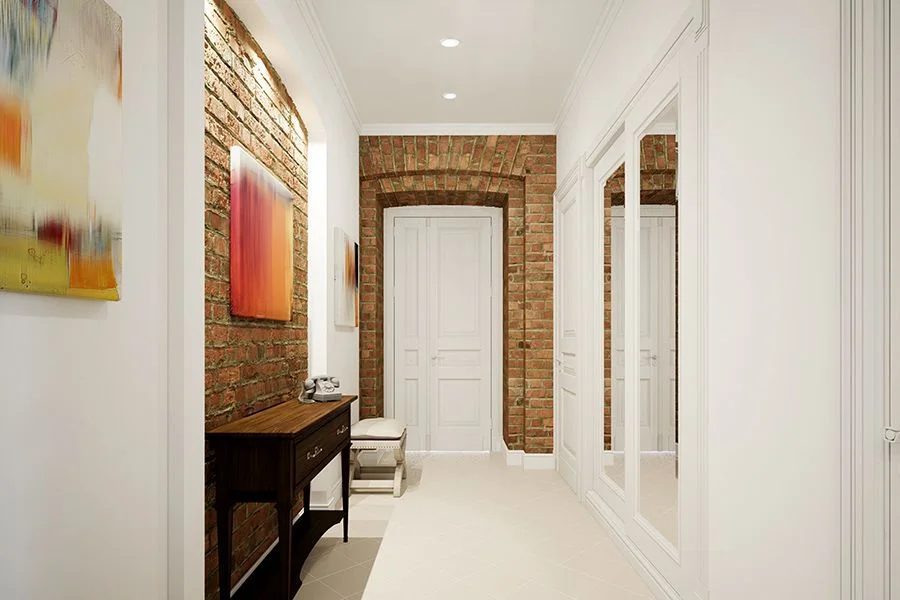 Residential corridor with exposed brick and recessed downlights