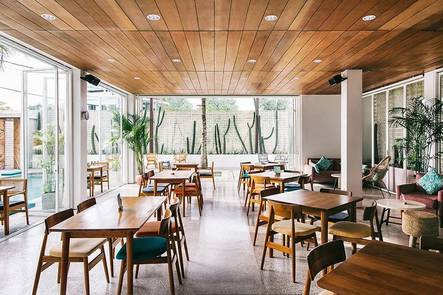 Restaurant with wood plank ceiling and small-aperture recessed downlights